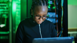 A woman peruses data on her laptop screen